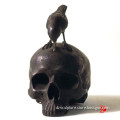 Bronze skull statue with bird sculpture for decoration